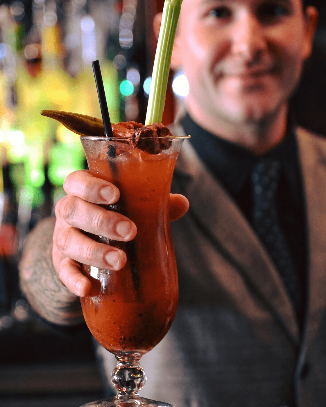 Bartender presenting a Bloody Mary cocktail